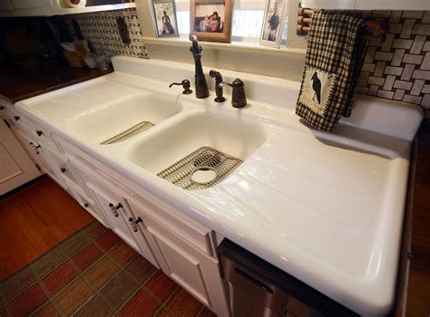 White Wooden Storage Cabinet With Double Cast Iron Sink And Drainboard