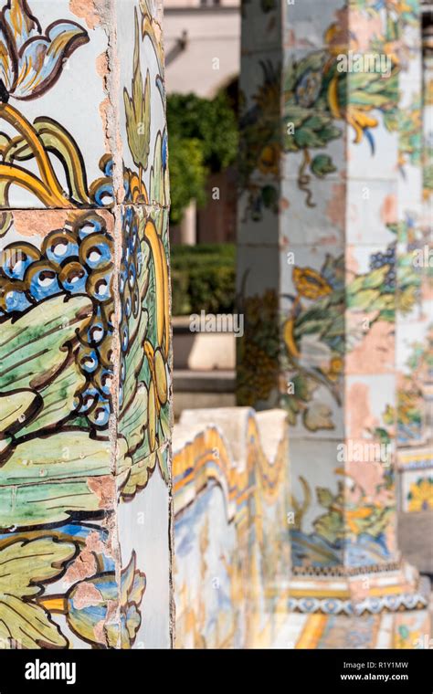 colourful tiled pillars and bench in the cloister garden at the santa chiara monastery in via