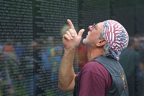 An Unidentified Vietnam Veteran Looks For His Friends Name On The