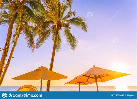 Beautiful Tropical Nature Umbrella Chair With Palm Tree Around Beach