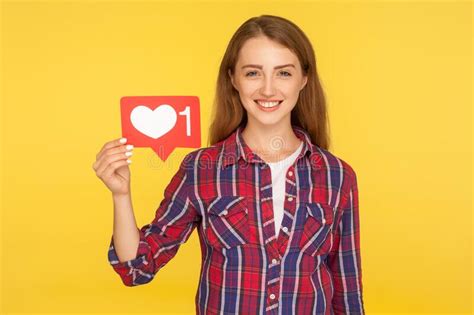 Portrait Of Cheerful Ginger Girl In Checkered Shirt Smiling And Holding