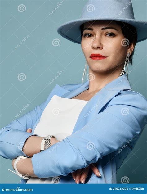 Attractive Confident Short Haired Brunette Woman In Blue Business Smart Casual Suit And Hat