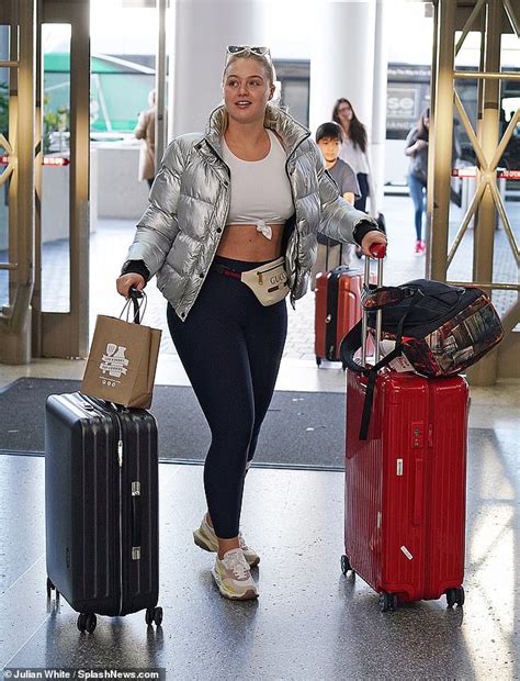 Iskra Lawrence Flashes Her Midriff In A White Crop Top And Leggings As She Jets