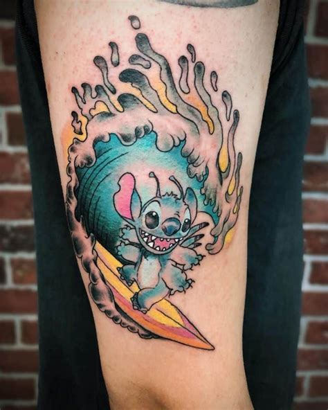 A Person With A Tattoo On Their Arm Holding A Surfboard