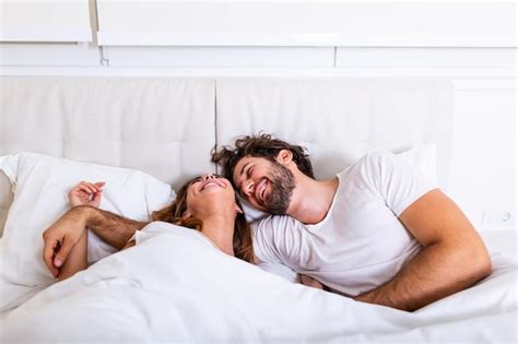 Premium Photo Happy Couple Is Lying In Bed Together Enjoying The Company Of Each Other Happy
