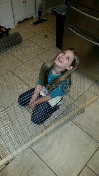 Young Laughing Girl Sitting In Wire Cage Carlos Cunha