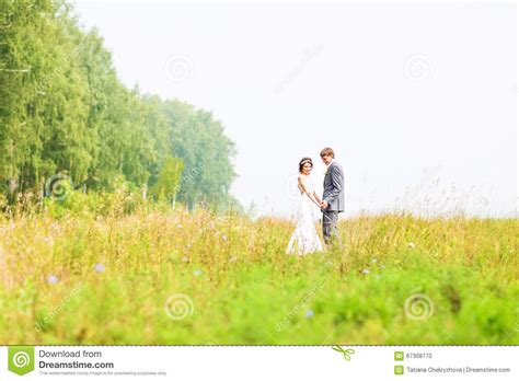 Beautiful Bride And Groom Standing In Grass Wedding Couple Stock Photo