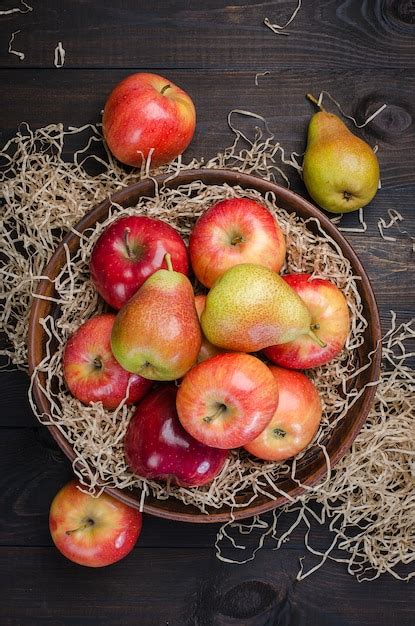 Premium Photo Red Apples And Pears On A Wooden Dark Rustic Background