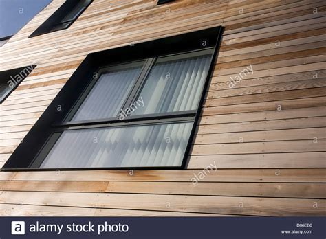 We Look Upwards To Wooden Panels On Exterior Walls Of