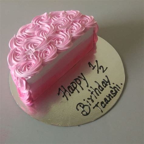 A Birthday Cake With Pink Frosting And Roses On It
