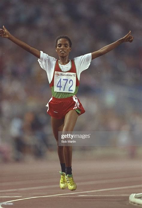 Derartu Tulu Of Ethiopia Holds Her Arms Aloft As She Crosses The Line