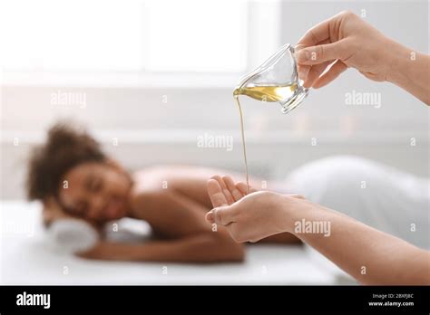 Woman Therapist Applying Massage Oil On Hands Before Therapy Stock