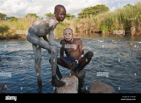 Two Surma Men With Body Paintings In The River Kibish Omo River