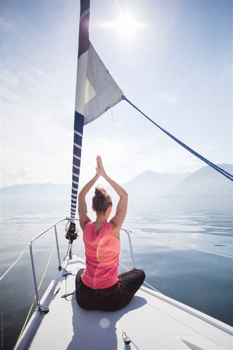 Woman Doing Yoga On A Sailing Boat Back View Del Colaborador De