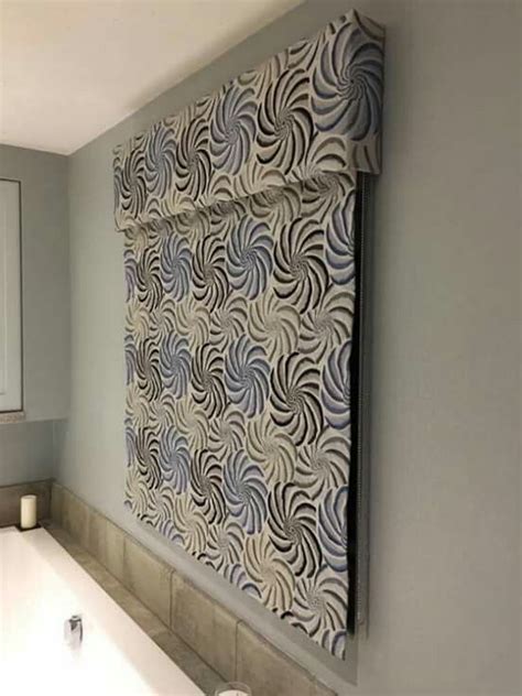 Let us help you design the fabric or woven window treatments that you want in the dimensions you need. Blue and grey embroidered linen roman blind with a pattern ...