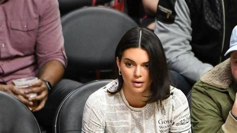 Kendall Jenner Wears A John Galliano Newspaper Print Tee To A Los Angeles Clippers Game Vogue
