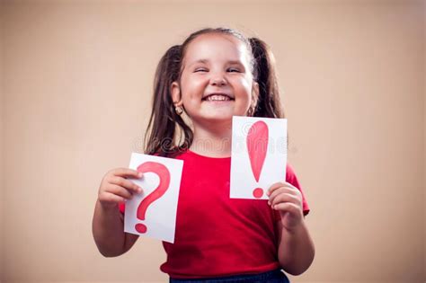 A Portrait Of Kid Girl Holding Cards With Exclamation Point And