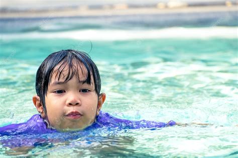 Premium Photo Cute Asian Girl Floating In The Water In A Swimming Pool