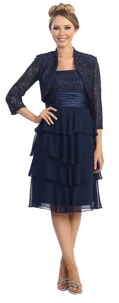 Alex evenings tops this tiered gown with a cropped jacket featuring a glittery pattern that matches the bust of the dress. Tiered Skirt Short Formal Party Dress with Lace Jacket 45463