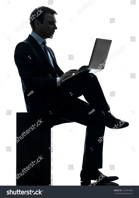 One Caucasian Businessman Computing Laptop Computer In Silhouette