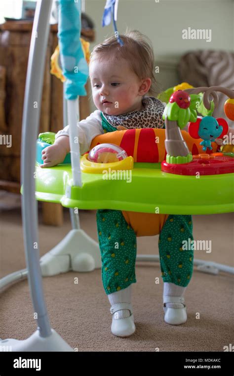 Baby In Jumperoo Watching Television Stock Photo Alamy