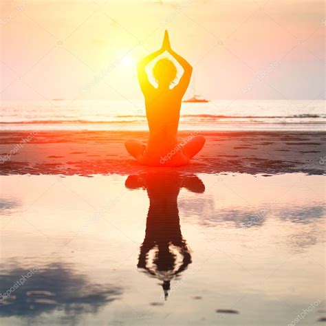 Silhouette Of A Beautiful Yoga Woman On The Beach At
