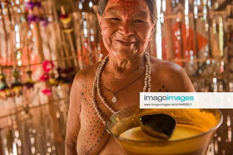 Indigenous Woman In Dessana Village Showing Typical Food Vase Brazil State Of Amazonas Manaus