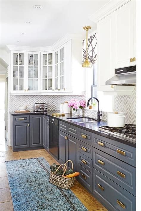 White Upper Cabinets And Gray Lower Cabinets With Brass Hardware