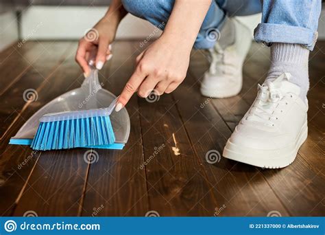 Womanand X27s Hands Sweeping Dust With Brush And Dustpan Holding Broom