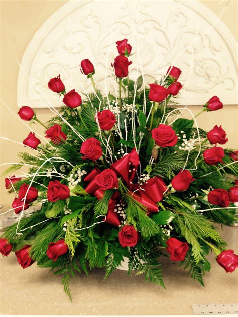 Funeral flowers help celebrate the life of a friend or loved one. Red rose funeral basket with fresh white pine and cedar ...