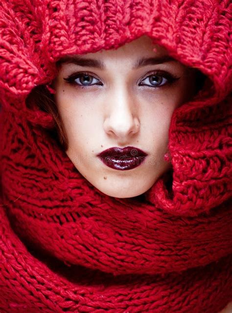 Young Pretty Woman In Sweater And Scarf All Over Her Face Stock Image