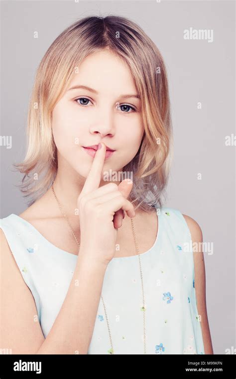 Young Girl With Blonde Bob Hairstyle Teen Girl Holding Her Finger To