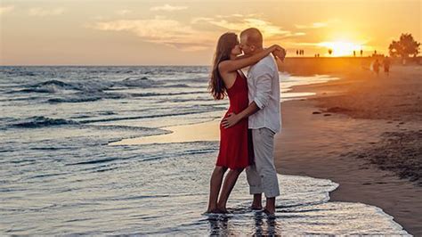 Couple Is Standing On Beach Kissing In Sunrise Background Hd Couple