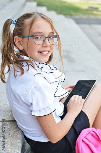 Smiling Cute Babegirl Of Primary Babe In Glasses Girl With A Pink Bag Sitting On Stairs