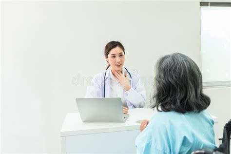 asian doctor woman is asking about the symptoms and checkup of elderly woman patients stock
