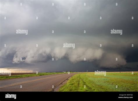 A Big Supercell Storm With A Shelf Cloud And A Wall Cloud Looms Over A
