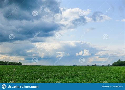 Dramatic Countryside Landscape With Thunderclouds In The Sky Over A