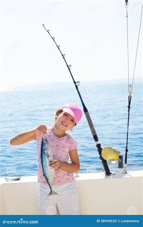 Child Little Girl Fishing In Boat Holding Little Tunny Fish Catch Stock