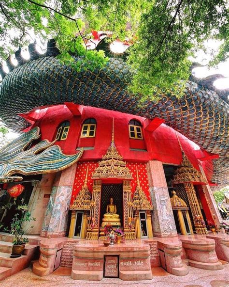 The Wat Samphran Dragon Temple Is A 17 Storey Red Tower With A Statue