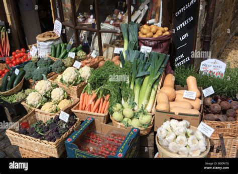 boxes of colourful vegetables outside a greengrocers shop in the cotswold village of broadway