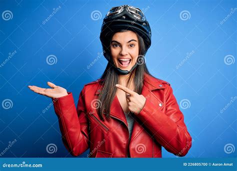 Young Beautiful Brunette Motorcycliste Woman Wearing Motorcycle Helmet And Jacket Amazed And