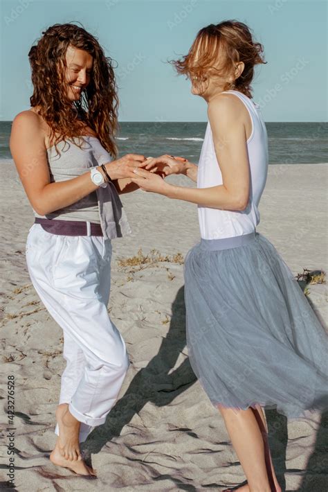 Woman Proposing To Her Happy Girlfriend On The Beach Lesbian Couple In Love Engagement In
