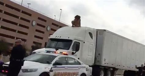 Naked Woman Dances Atop Giant Truck After Crash