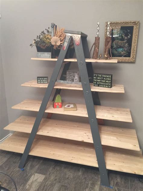 Old ladder decorated with ivy twigs. Old Wooden Ladder Transformed Into a Country Chic Shelf ...