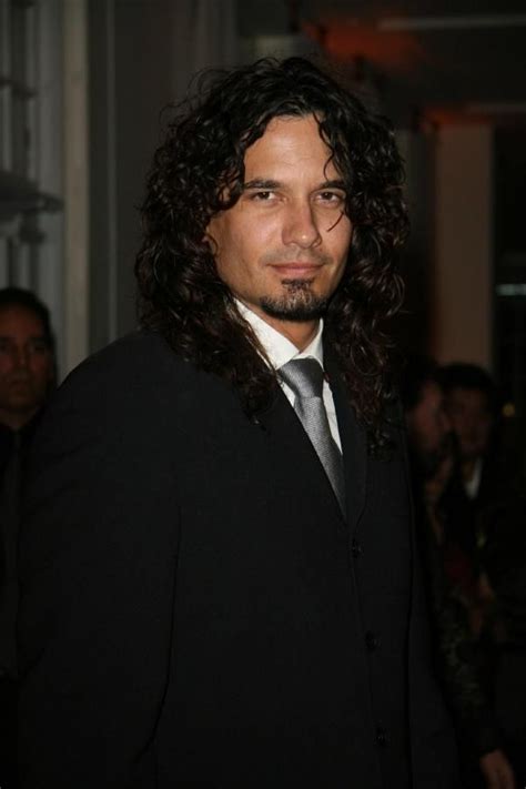 A Man With Long Hair Wearing A Suit And Tie