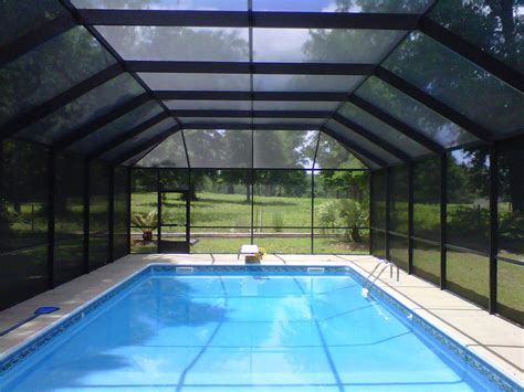 An Indoor Swimming Pool With Glass Walls And Tiled Flooring Surrounded
