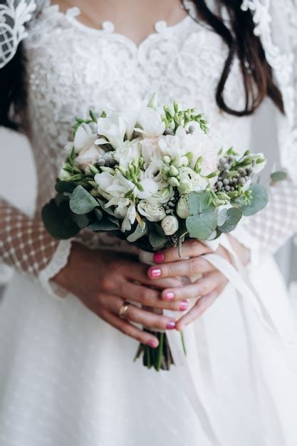 Bride Is Holding Beautiful Wedding Bouquet Of White Flowers And