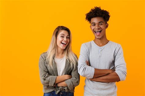 Premium Photo Happy Young Cute Loving Couple Posing Isolated Over Yellow Wall