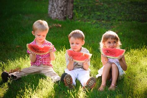 Premium Photo Funny Kids Eating Watermelon Outdoors In Summer Park