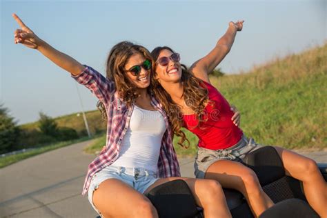 Two Beautiful Young Women Sitting On A Convertible Car Enjoying The Sunset Stock Image Image